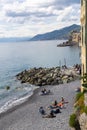 Panorama of the Camogli coast and beach with people. Little fishing village and resort close to the peninsula of Portofino
