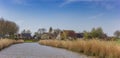 Panorama of a canal leading to the small village of Lichtaad in Friesland