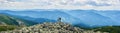 Panorama of Carpathian mountains with green forests, rear view pair is holding hands and enjoying powerful view.