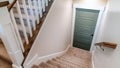 Panorama Carpeted U shaped staircase that leads down to the basement door of a home Royalty Free Stock Photo