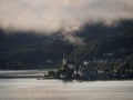 Panorama of catholic pilgrimage church Maria Woerth Rosenkranzkirche alpine mountain lake Woerthersee Carinthia Austria