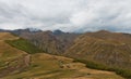 Panorama of Caucasian mountains near Gergeti Trinity Church, village of Gergeti and Stepancminda in Georgia.