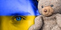 Panorama Childrens eyes full of sadness in Ukraine colors with teddy bear