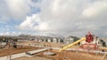 Panorama Childrens playground against snow capped mountain and cloudy sky in winter