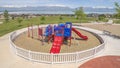 Panorama Childrens playground ovelooking homes lake and snow peaked mountain under sky