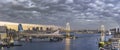 Panorama of the circular highway leading to the Rainbow Bridge with Cargo and cruise ships moored or sailing in Odaiba Bay of