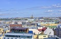 Panorama of the city. The multi-colored roofs of buildings, the domes of the cathedral, the showcase of a glass cafe Royalty Free Stock Photo