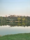 Panorama of the city park. Reflection of buildings and trees in the water. City environment. Royalty Free Stock Photo