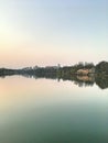 Panorama of the city park. Reflection of tall buildings in the lake.
