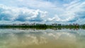 Panorama of city reflection in water under clouds during daytime Royalty Free Stock Photo