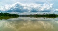 Panorama of city reflection in water under clouds during daytime Royalty Free Stock Photo