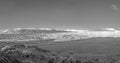 City of Reno Nevada cityscape with hotels and casinos and snow covered mountains in monochrome panorama.