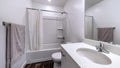 Panorama Clean white bathroom interior with oval sink mirror toilet bathtub and shower