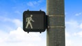 Panorama Close up of pedestrian traffic light signal against blue sky and bright clouds Royalty Free Stock Photo
