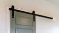 Panorama Closed sliding gray panel door with black handle against white wall of home Royalty Free Stock Photo