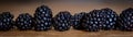 Panorama, closeup of fresh raw blackberries on wooden table