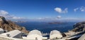 Panorama of the coast on the island of Santorini caldera in Greece. The background is a blue sky with white clouds Royalty Free Stock Photo