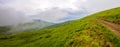 Panorama of cold foggy summer morning in the Carpathian mountain Royalty Free Stock Photo