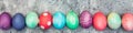 Panorama, colorful dyed easter eggs in a line, easter season handicraft
