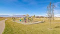 Panorama Colorful kids playground in a grassed urban park Royalty Free Stock Photo