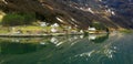 Panorama of colorful Scandinavian houses reflected in Norwegian fjord