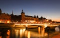 Panorama of Conciergerie and Illuminated bridge Pont au Change at night, Paris. Royalty Free Stock Photo