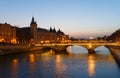 Panorama of Conciergerie and Illuminated bridge Pont au Change at night, Paris. Royalty Free Stock Photo