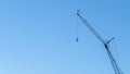 Panorama Construction crane for lifting and lowering materials isolated against blue sky