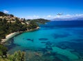 Panorama of Corfu beach and sea with plane overflying to the shore