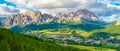 Panorama of Cortina d`Ampezzo with green meadows and alpine peaks on the background. Dolomites, Italy. Royalty Free Stock Photo