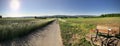 Panorama of country field with a speed bike on a country road Royalty Free Stock Photo