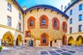 Panorama of the courtyard of Palazzo Borromeo with scenic medeival frescoes on the wall, Milan, Italy