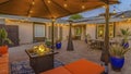 Panorama Cozy brick patio of a home with colorful seating area under a pavilion Royalty Free Stock Photo