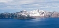 Panorama of Crater Lake blue water with Wizard Island and snow on rim Royalty Free Stock Photo