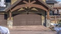 Panorama crop Home in Park City Utah in winter with gabled garage entrance against blue sky Royalty Free Stock Photo