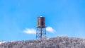 Panorama Cylindrical water storage tank container on a steel tower at Wasatch Mountains Royalty Free Stock Photo