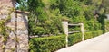 Panorama of decoration of the entrance with stone columns and a green fence Royalty Free Stock Photo