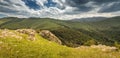 Dirt village road leading to the Pushkin pass in the mountains of Armenia. Wind farm turbines are installed on the