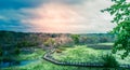 Panorama of a dramatic cloudy sky at sunset over michigan preserve boardwalk in natural wilderness Royalty Free Stock Photo