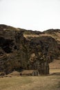 Panorama of Drangurinn i Drangshlid boulder rock formation historical landmark turf house building in South Iceland