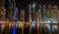 Panorama of Dubai Skyline at night with colorful reflections on the water