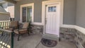 Panorama Entrance of home with chairs at the porch and front door with glass panes Royalty Free Stock Photo