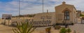 Panorama Entrance of Kolmanskop Ghost Town in Namibia with the sign Kolmanskuppe in german language