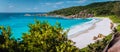 Panorama of epic Grand Anse Beach in La Digue island, Seychelles. White sand beach, big ocean waves and unique granite