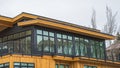 Panorama Exterior of a home with balcony shiny windows and gray and brown wood wall