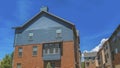 Panorama Exterior of houses with red brick and wooden wall under blue sky on a sunny day