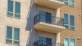 Panorama Exterior of a residential building with small balconies viewed on a sunny day