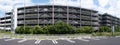 A panorama of the exterior of a 6-story parking garage, car park, or parkade at AEON Mall