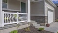 Panorama Facade of a home with view of the porch green front door and white garage door Royalty Free Stock Photo