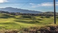 Panorama Fence with golf course homes and mountain against blue sky on the other side Royalty Free Stock Photo
